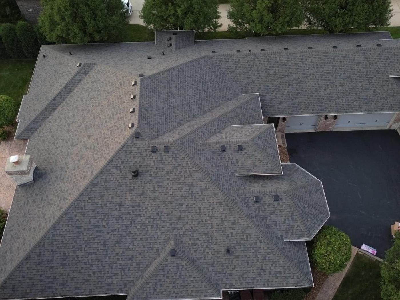 Drone view of a large ranch on a golf-course lot in Frankfort with a new gray roof