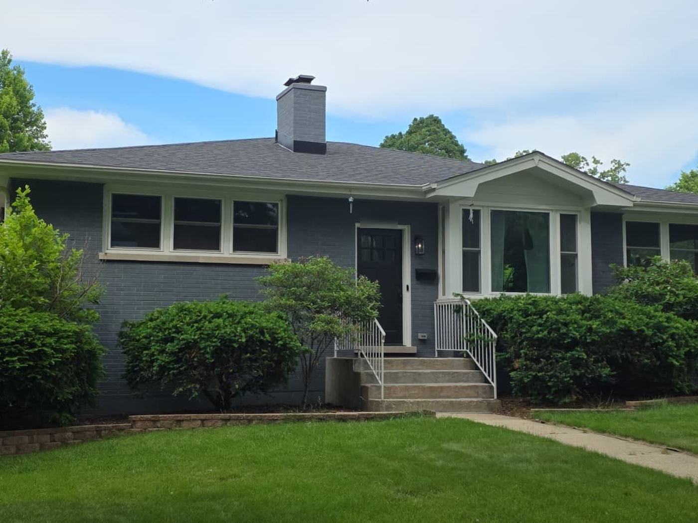 Gray brick ranch in Naperville with a new dark-gray roof