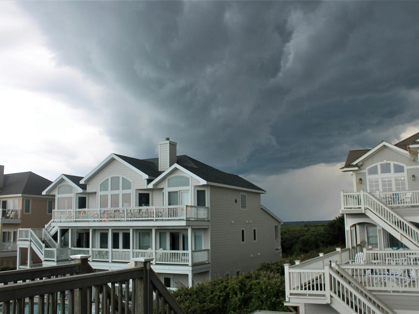 Storm clouds over a suburban roofline