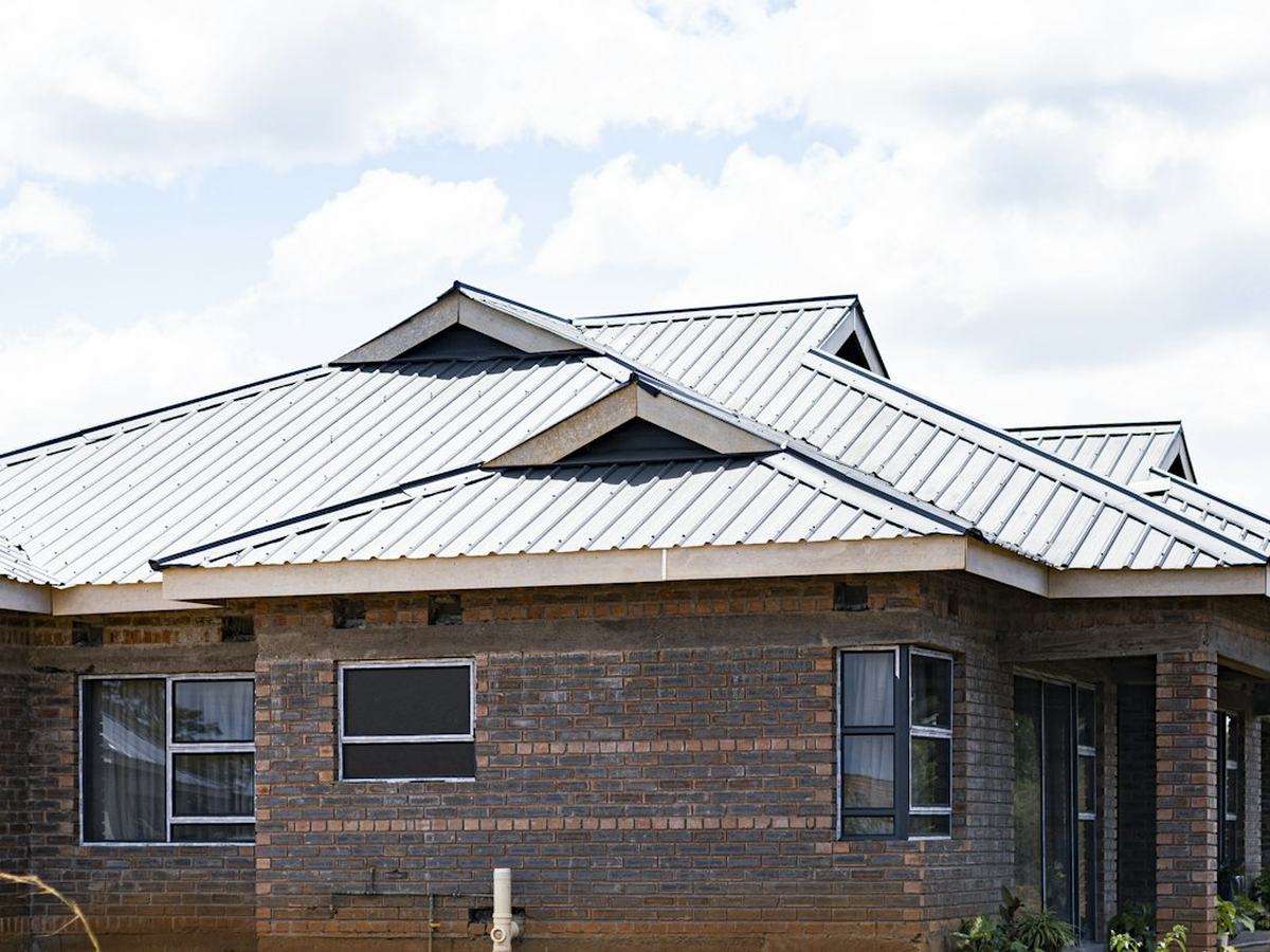 Dark brick home with a light metal roof