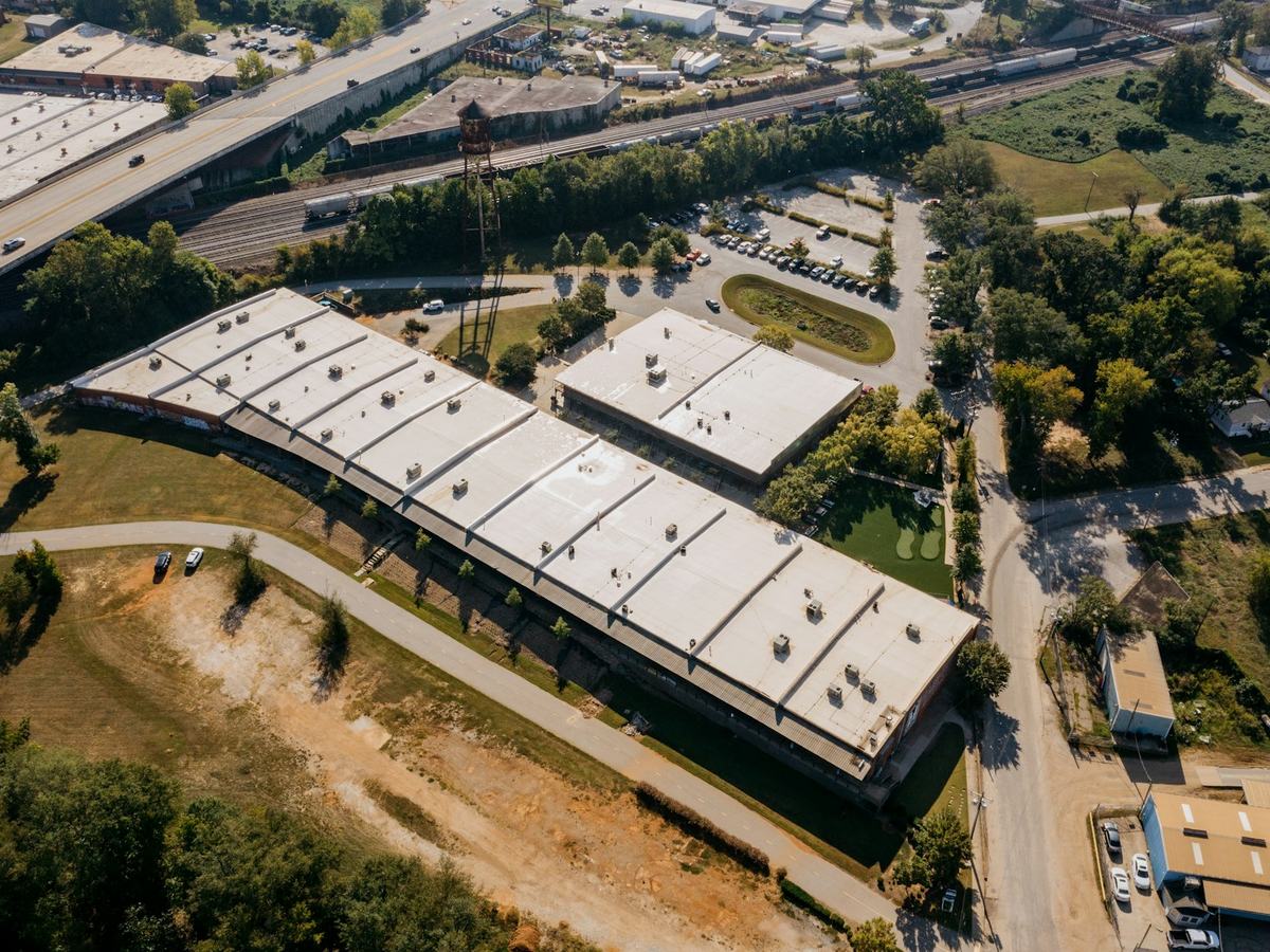 Aerial view of a commercial building with a white membrane flat roof