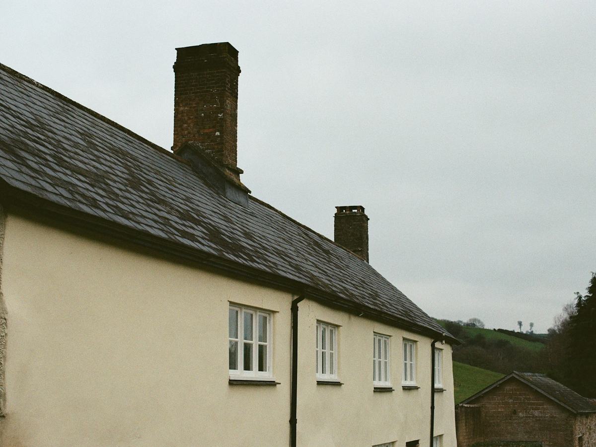 Stone house with a natural slate roof and chimneys